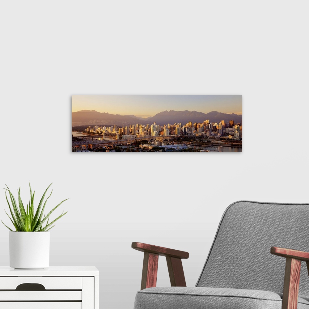 A modern room featuring Cityscape panorama of Vancouver Canada with the harbor and bridges in the foreground going to Van...