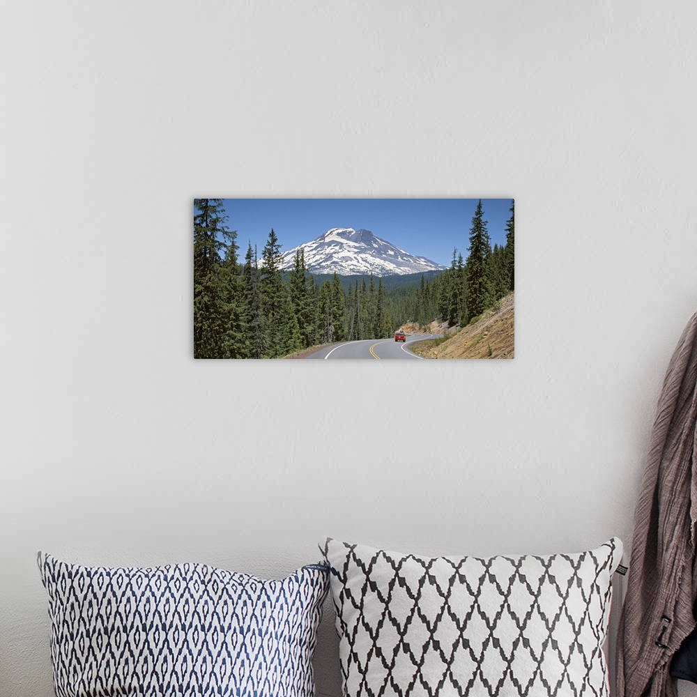 A bohemian room featuring Vehicle moving on a road with South Sister Mountain in background, Oregon