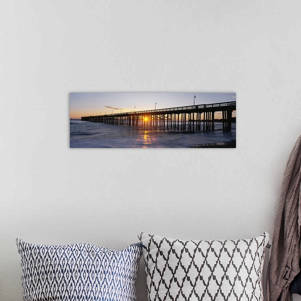 A bohemian room featuring Panoramic photo on canvas of the silhouette of a pier going out into the ocean against a sunset.