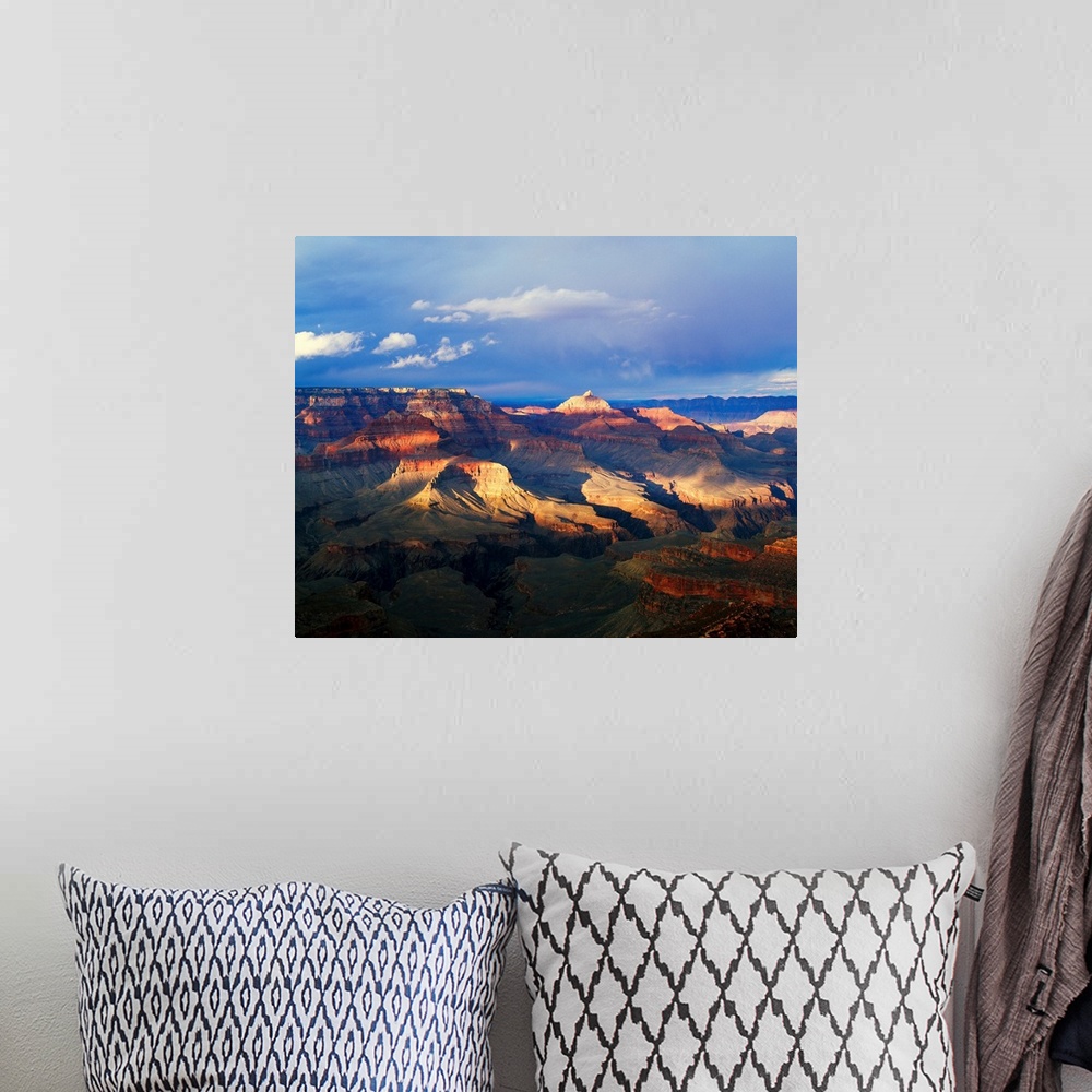 A bohemian room featuring This landscape photograph captures the light passing through the approaching storm and hitting th...