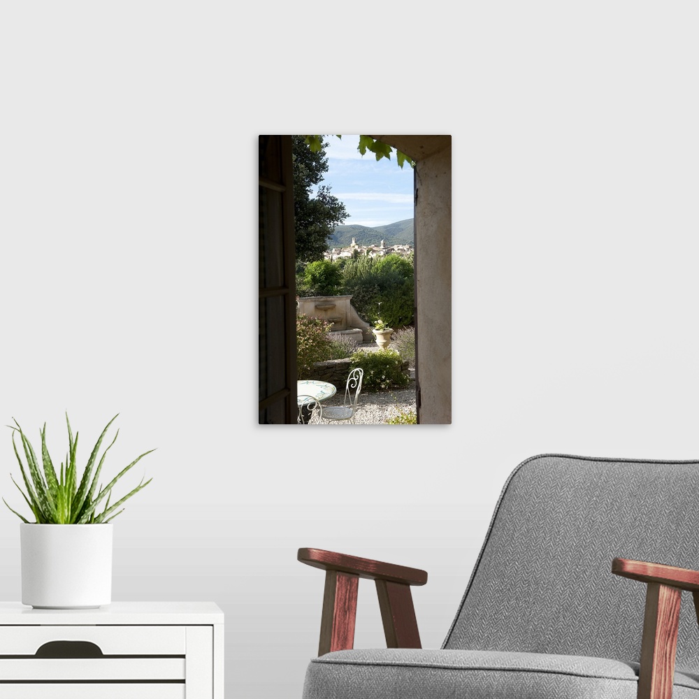 A modern room featuring Village viewed through from a window of a house, Lourmarin, Luberon