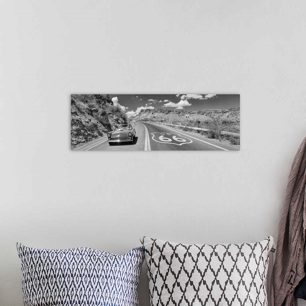 A bohemian room featuring Panoramic photo of a retro car driving down a road on Route 66 in Arizona.