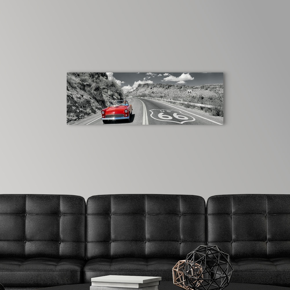 A modern room featuring Panoramic photograph displays a classic car cruising down a highway with rocky canyons on both si...