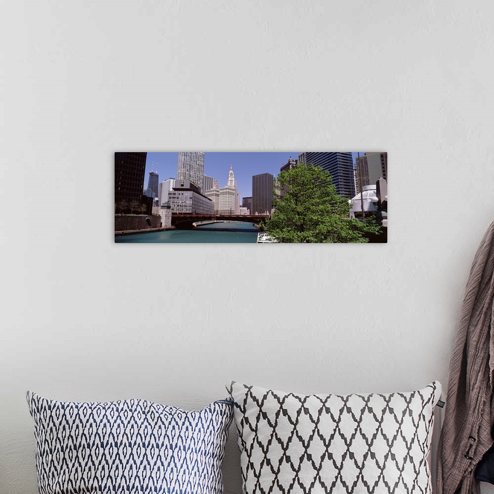 A bohemian room featuring Panoramic photograph of overpass with lake below and city buildings and skyscrapers in the backgr...