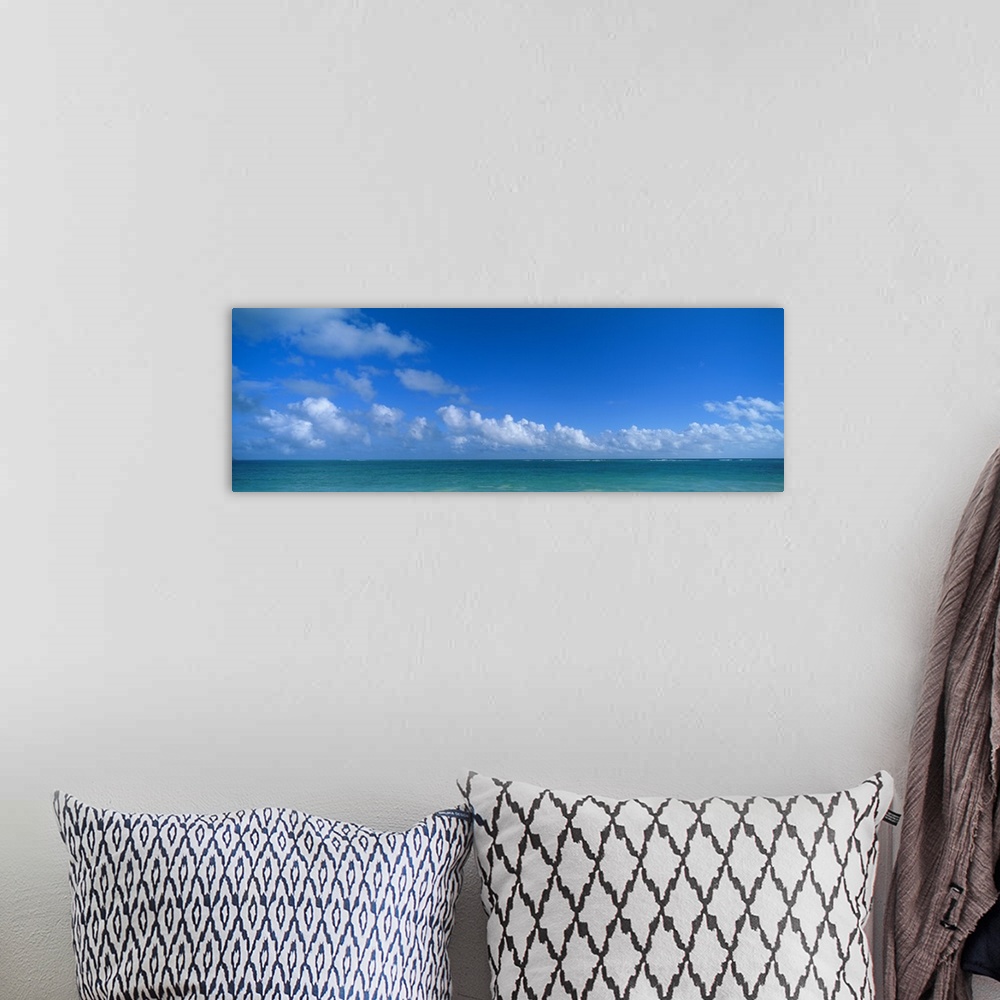 A bohemian room featuring Panoramic photograph of ocean under a cloudy sky.