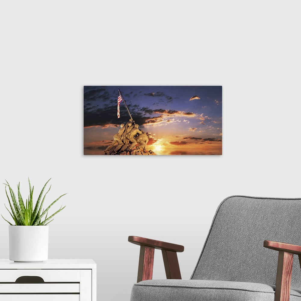 A modern room featuring Composite image of a statue of American soldiers raising a flag on a rocky mount and the sun sett...