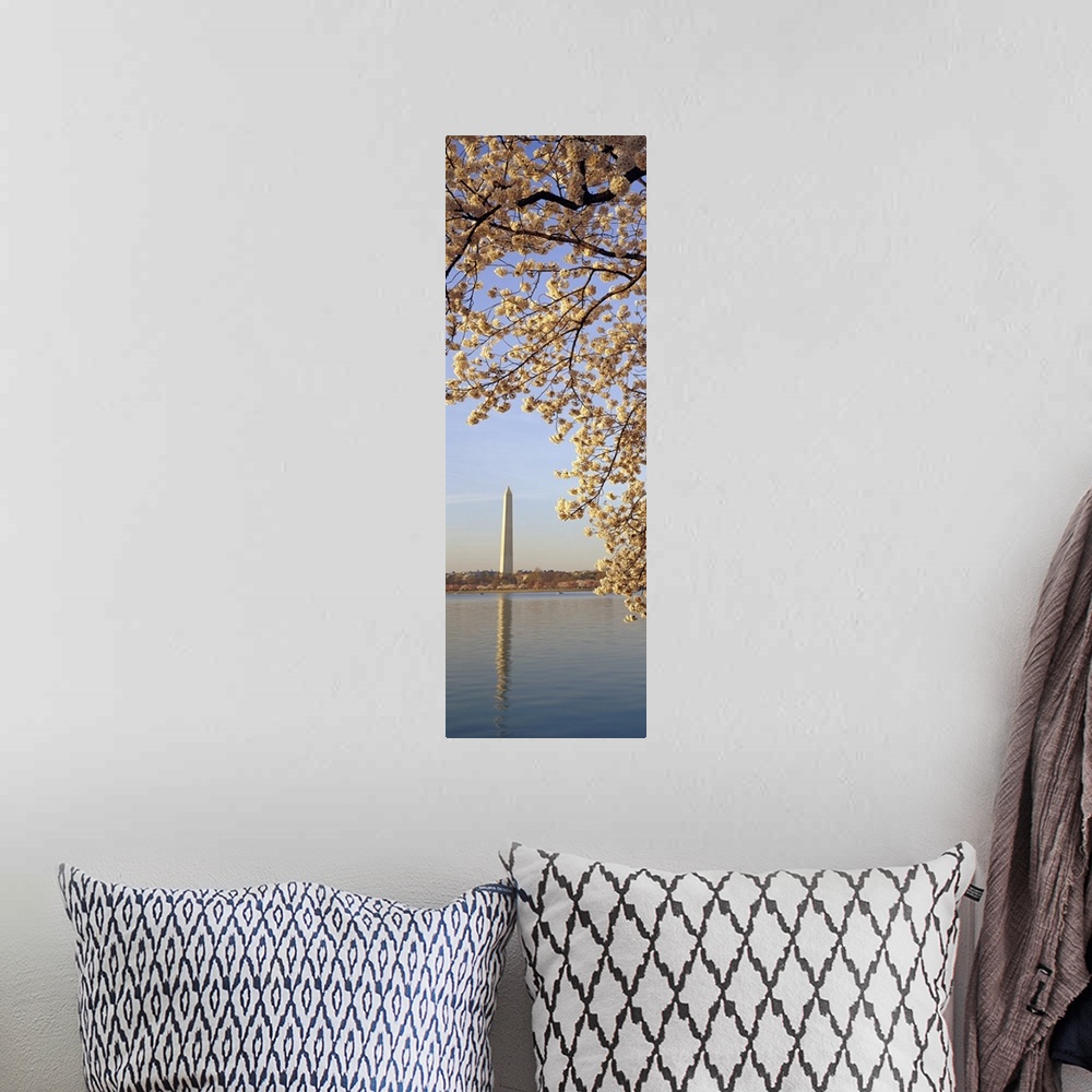 A bohemian room featuring Vertical, oversized photograph of  the branches of a cherry blossom tree in bloom, hanging over t...