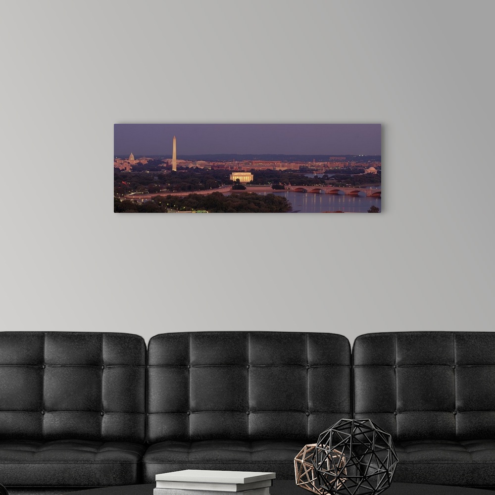 A modern room featuring Wide angle, aerial photograph of Washington DC at night, including the Washington Monument, the C...