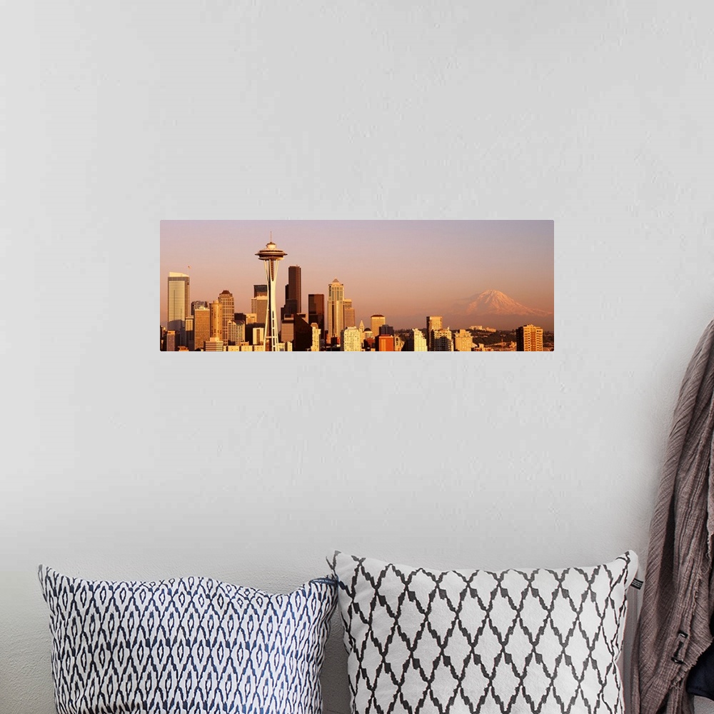 A bohemian room featuring This panoramic photograph is the city skyline at sunset with Mount Rainer in the background.