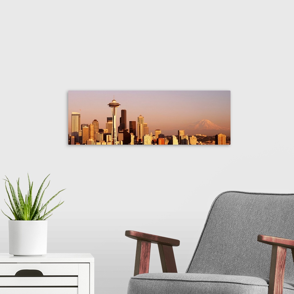 A modern room featuring This panoramic photograph is the city skyline at sunset with Mount Rainer in the background.