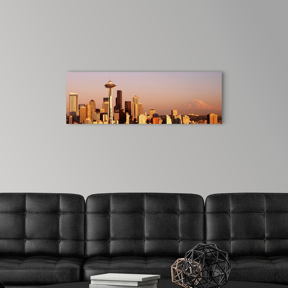 A modern room featuring This panoramic photograph is the city skyline at sunset with Mount Rainer in the background.
