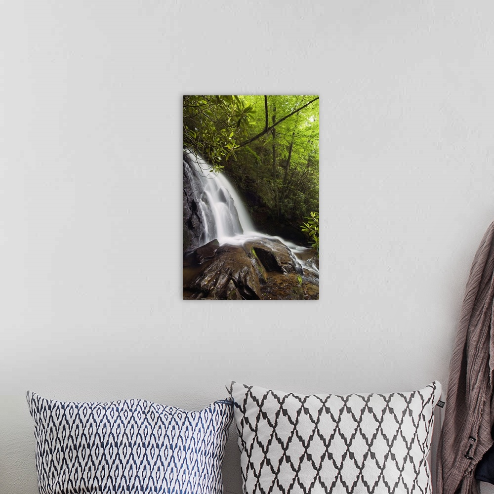 A bohemian room featuring This vertical nature photograph is a waterfall tumbling over large rocks in a forest in the Appal...