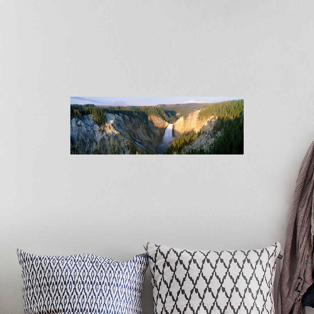 A bohemian room featuring Panoramic photograph of waterfall flowing through valley surrounded by snow and tree covered moun...