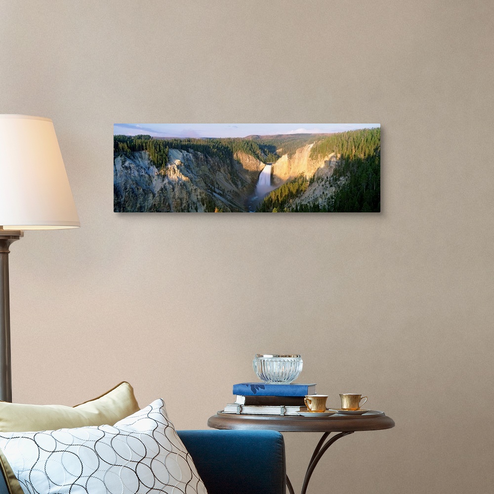A traditional room featuring Panoramic photograph of waterfall flowing through valley surrounded by snow and tree covered moun...