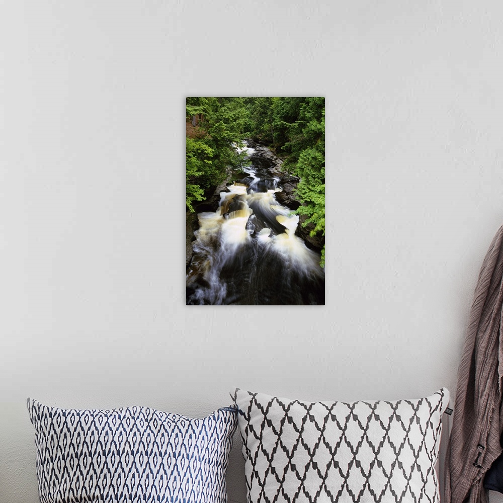 A bohemian room featuring Giant, vertical, high angle photograph of water rushing through the rocky Presque Isle River, sur...