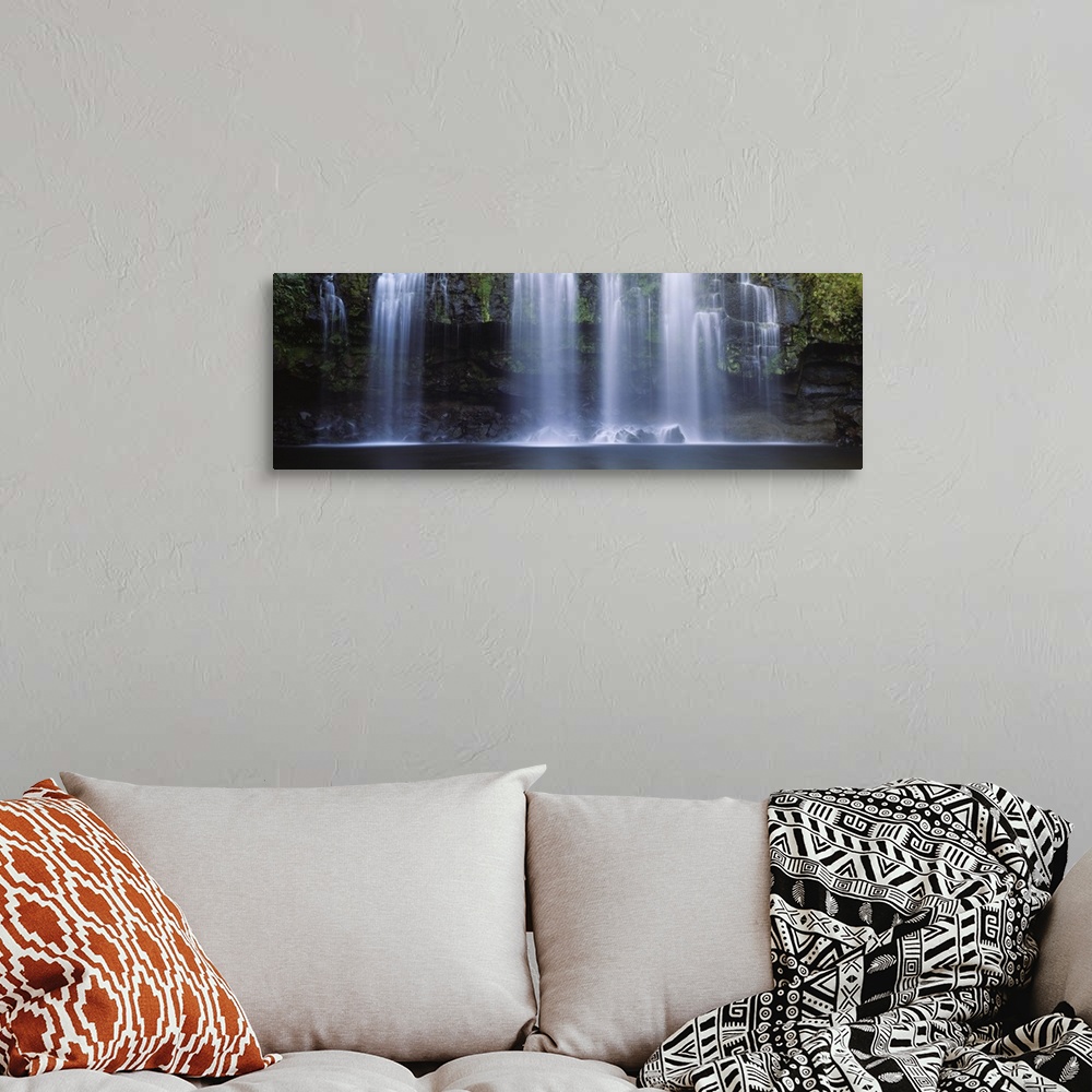A bohemian room featuring Multiple cascades fall over a moss covered rock face into a pool in this panoramic photograph of ...