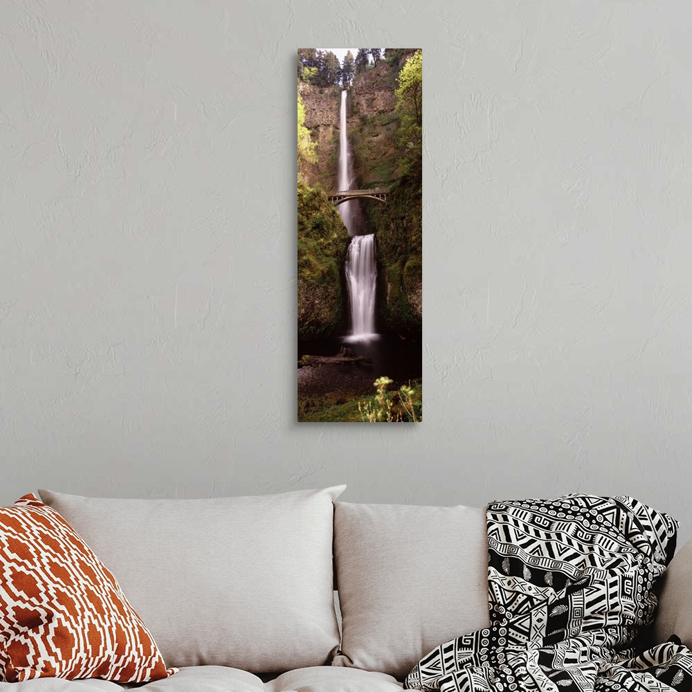 A bohemian room featuring Vertical panoramic photograph of water cascading over the edge of a high cliff and falling into a...