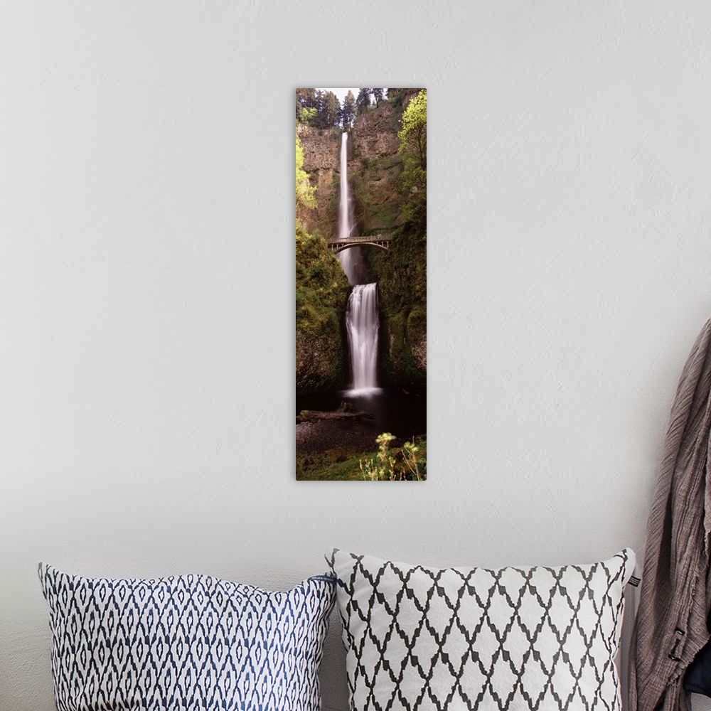 A bohemian room featuring Vertical panoramic photograph of water cascading over the edge of a high cliff and falling into a...