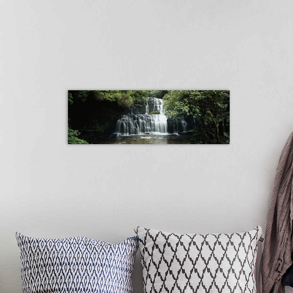 A bohemian room featuring Wide angle photograph of green trees and foliage surrounding Purakaunui Falls in the Catlins, on ...