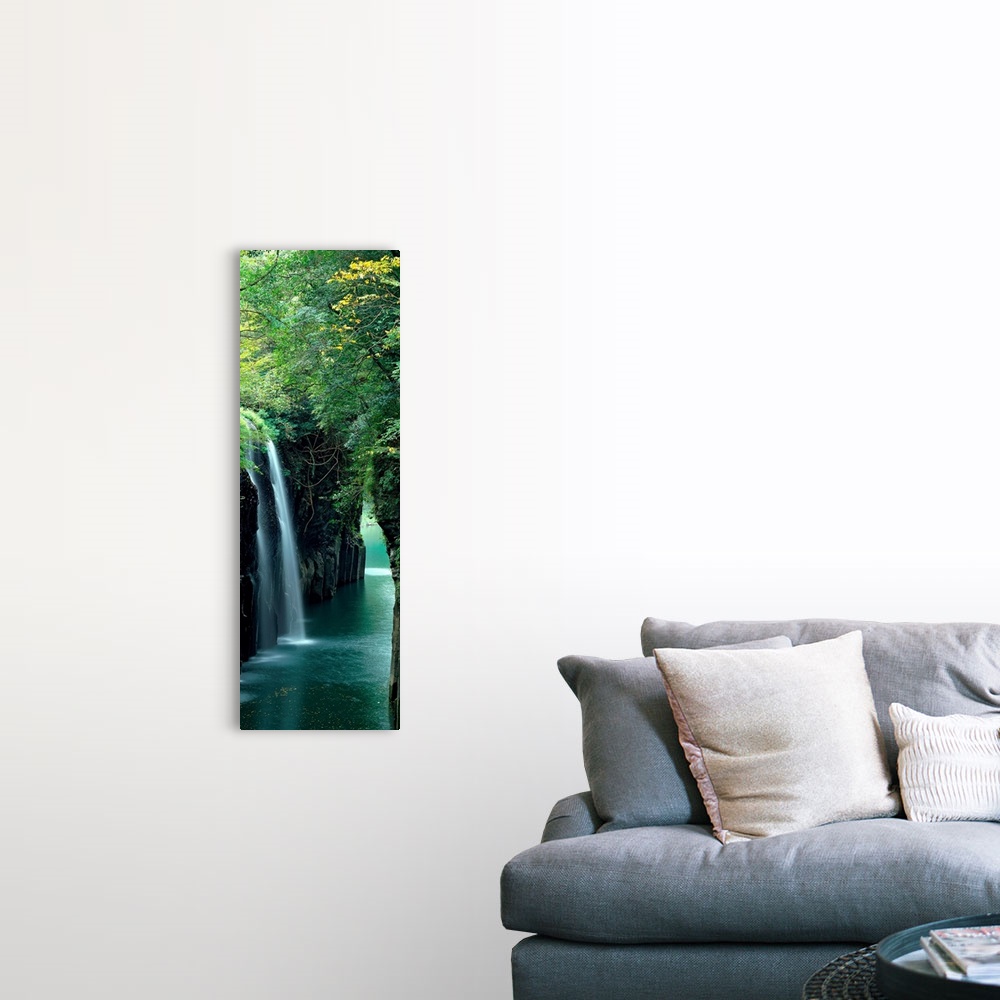 A farmhouse room featuring Vertical outdoor shot of a forest, river, and waterfall taken with time-lapsed photography.