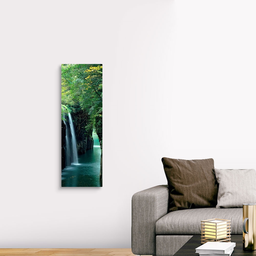 A traditional room featuring Vertical outdoor shot of a forest, river, and waterfall taken with time-lapsed photography.