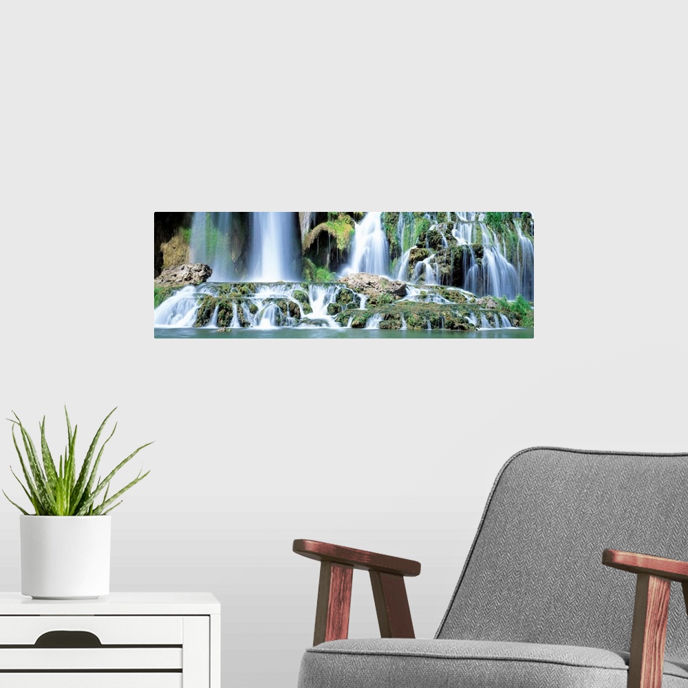 A modern room featuring Serene wall art for the home or office a panoramic photograph of the bottom of a rocky waterfall ...