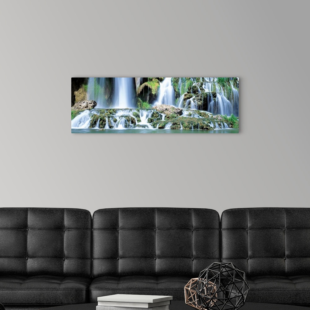 A modern room featuring Serene wall art for the home or office a panoramic photograph of the bottom of a rocky waterfall ...