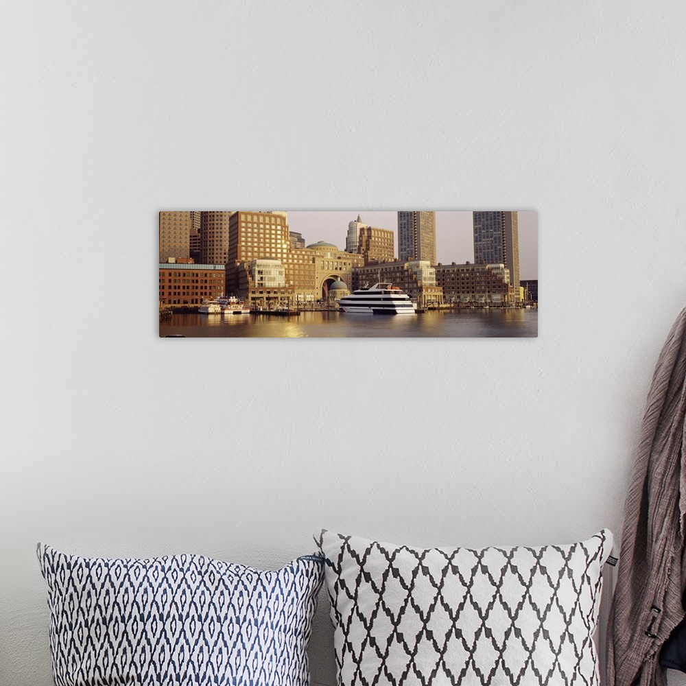 A bohemian room featuring Landscape photograph on a large canvas of boats in the water along the shore of Boston, Massachus...