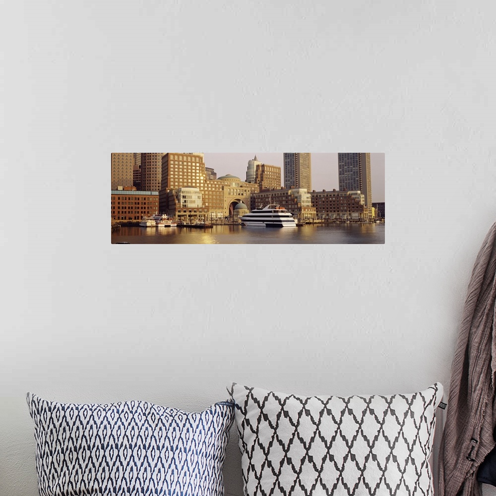 A bohemian room featuring Landscape photograph on a large canvas of boats in the water along the shore of Boston, Massachus...