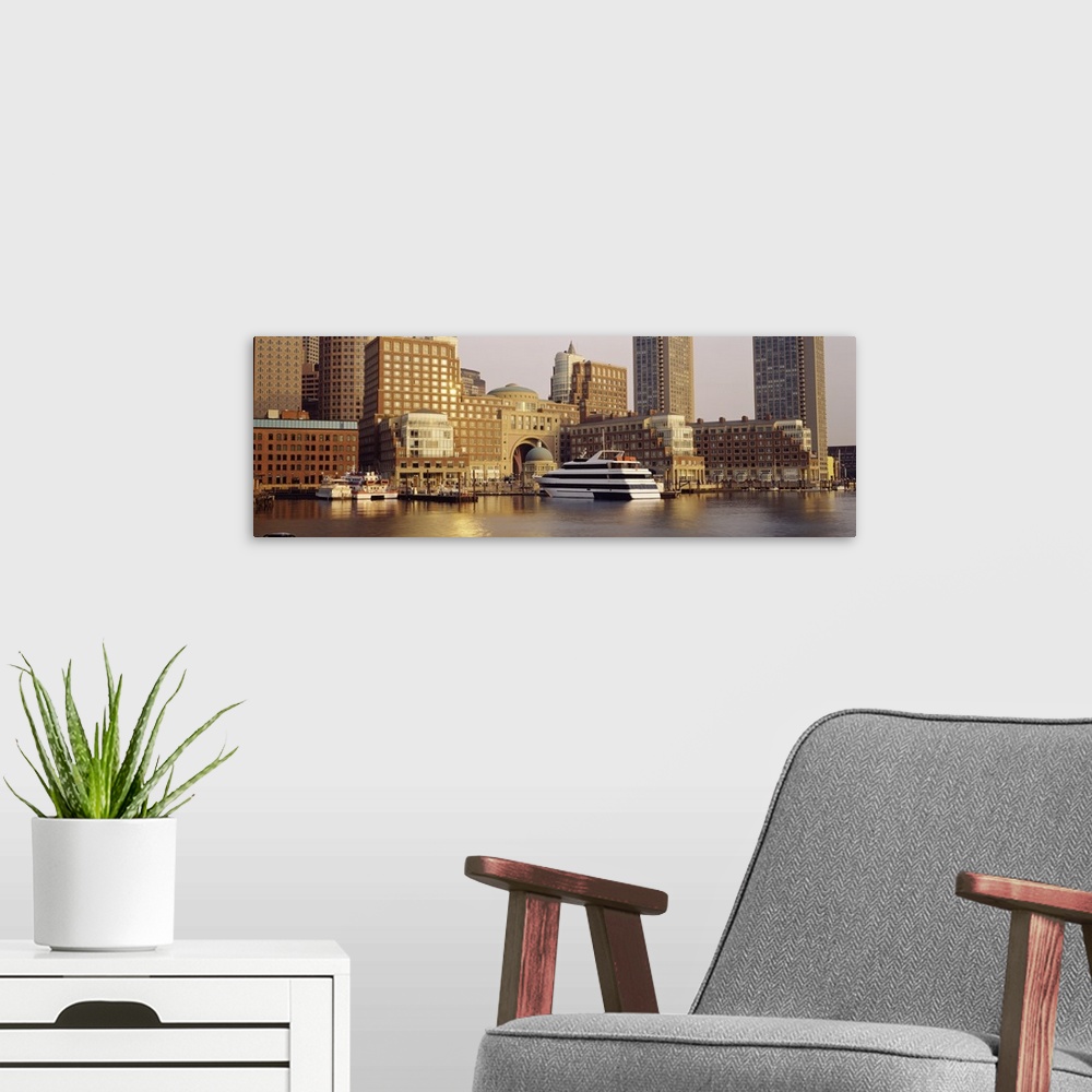 A modern room featuring Landscape photograph on a large canvas of boats in the water along the shore of Boston, Massachus...