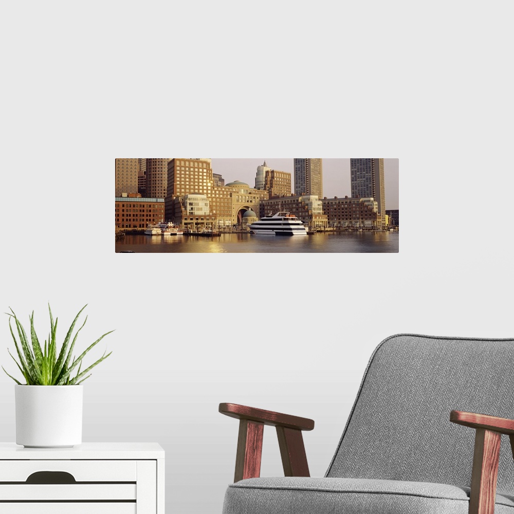 A modern room featuring Landscape photograph on a large canvas of boats in the water along the shore of Boston, Massachus...