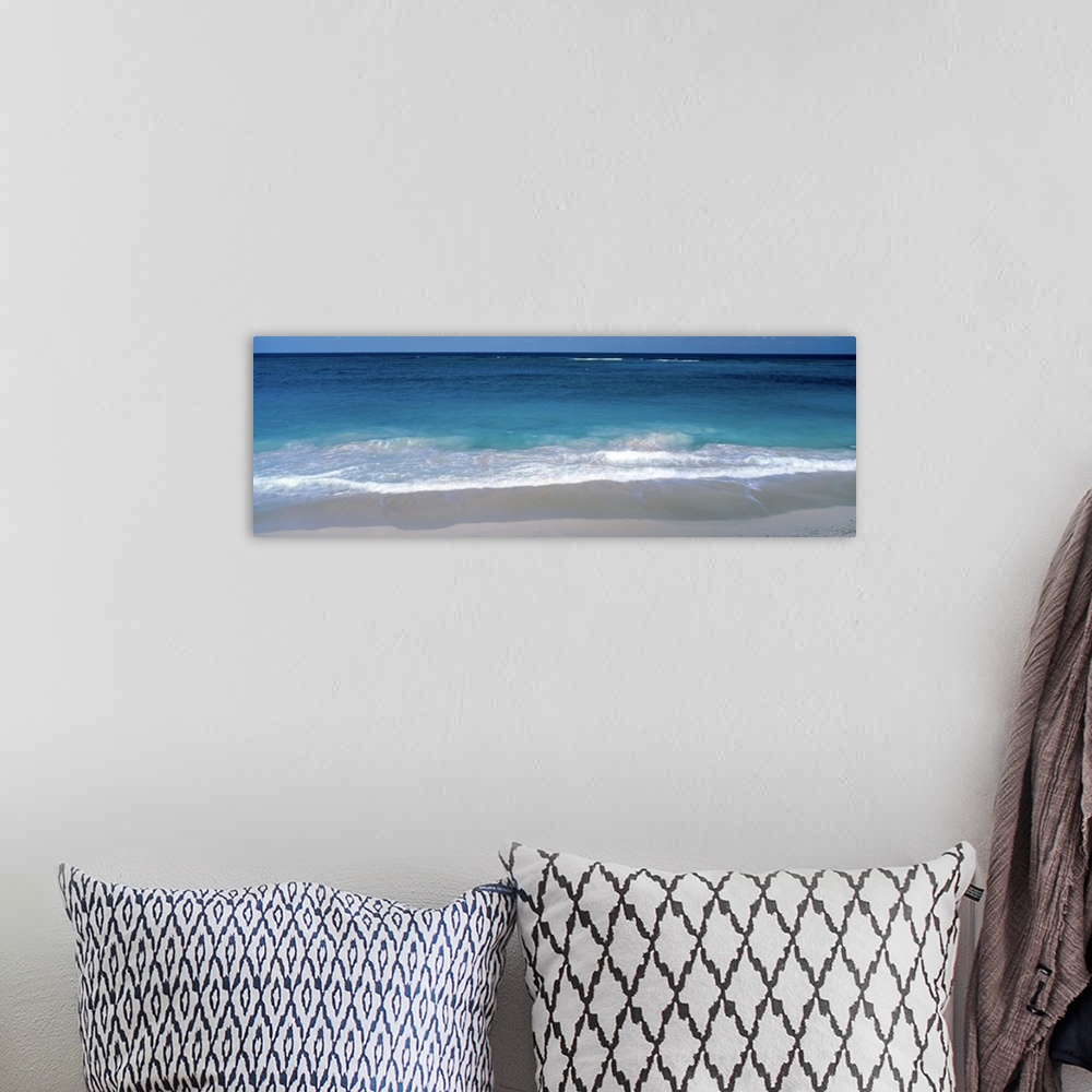 A bohemian room featuring Panoramic picture of waves coming up on the white sandy beach in the Caribbean.