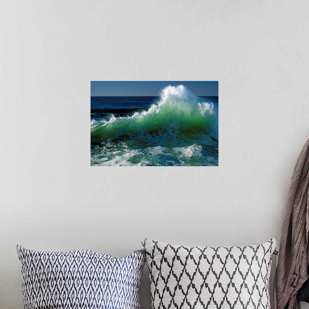 A bohemian room featuring This wall art for the office or home is a landscape photograph of a wave breaking near the shore.