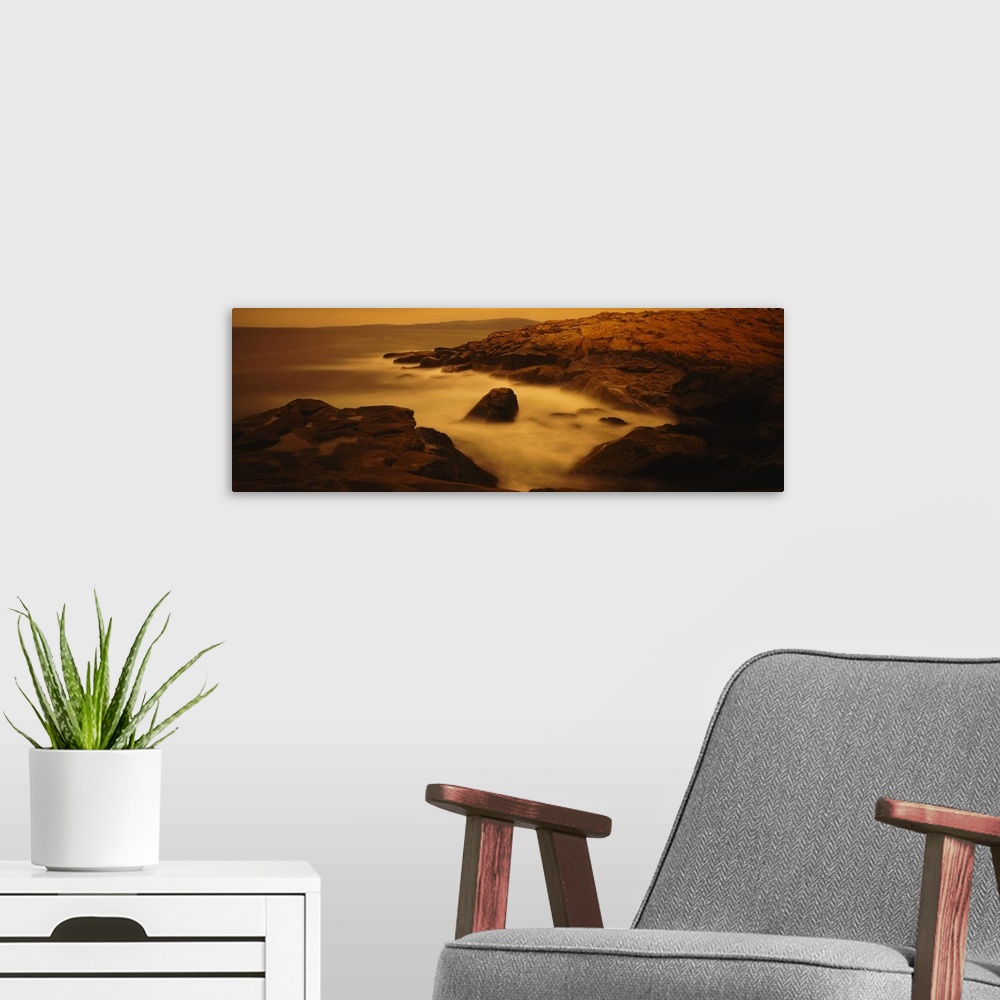 A modern room featuring Large photograph of misty waters surrounding rocks in the Acadia National Park on the Schoodic Pe...