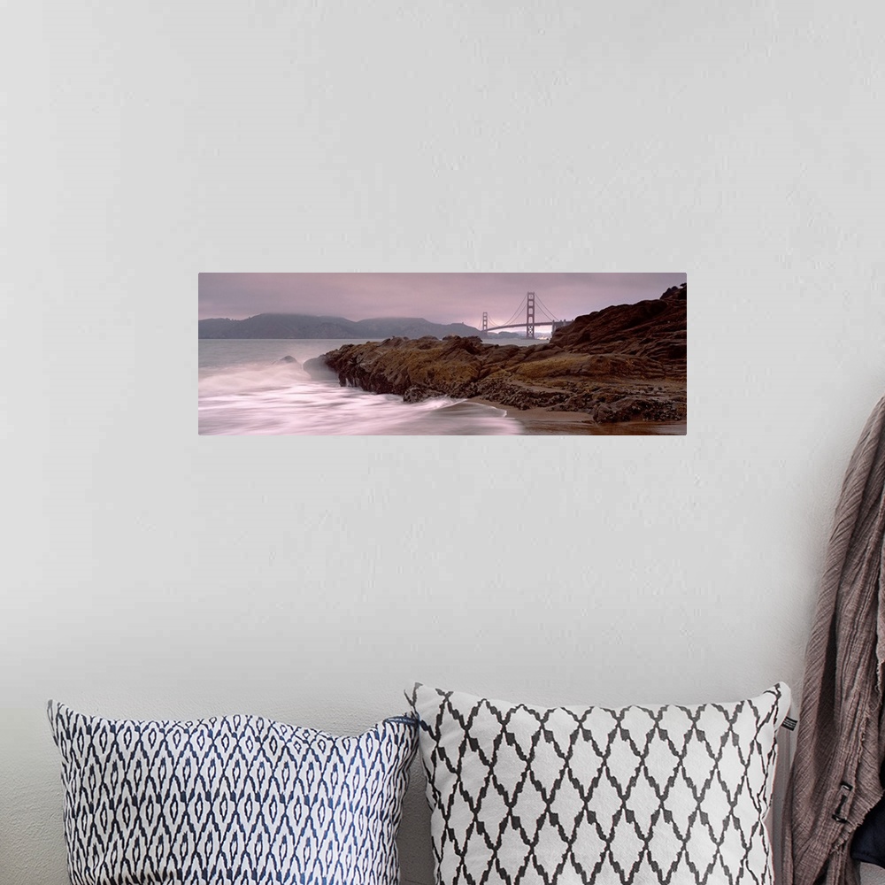 A bohemian room featuring Panoramic photograph shows waves breaking against the rocky shores of Baker Beach in San Francisc...