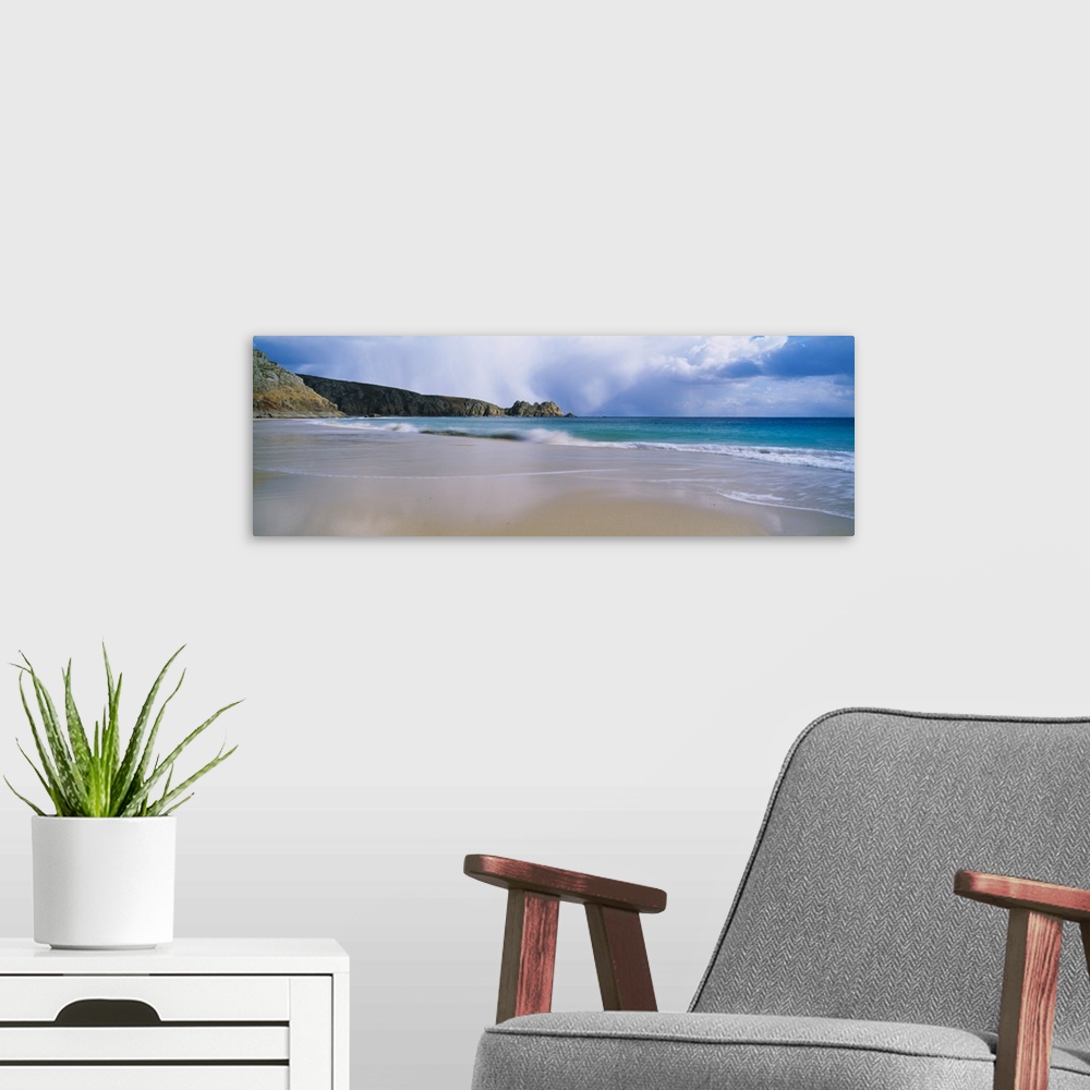 A modern room featuring Waves breaking on the beach Logan Rock Porthcurno Bay Cornwall England