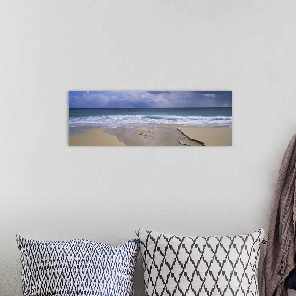 A bohemian room featuring Waves breaking on the beach, Porthcurno Bay, Cornwall, England