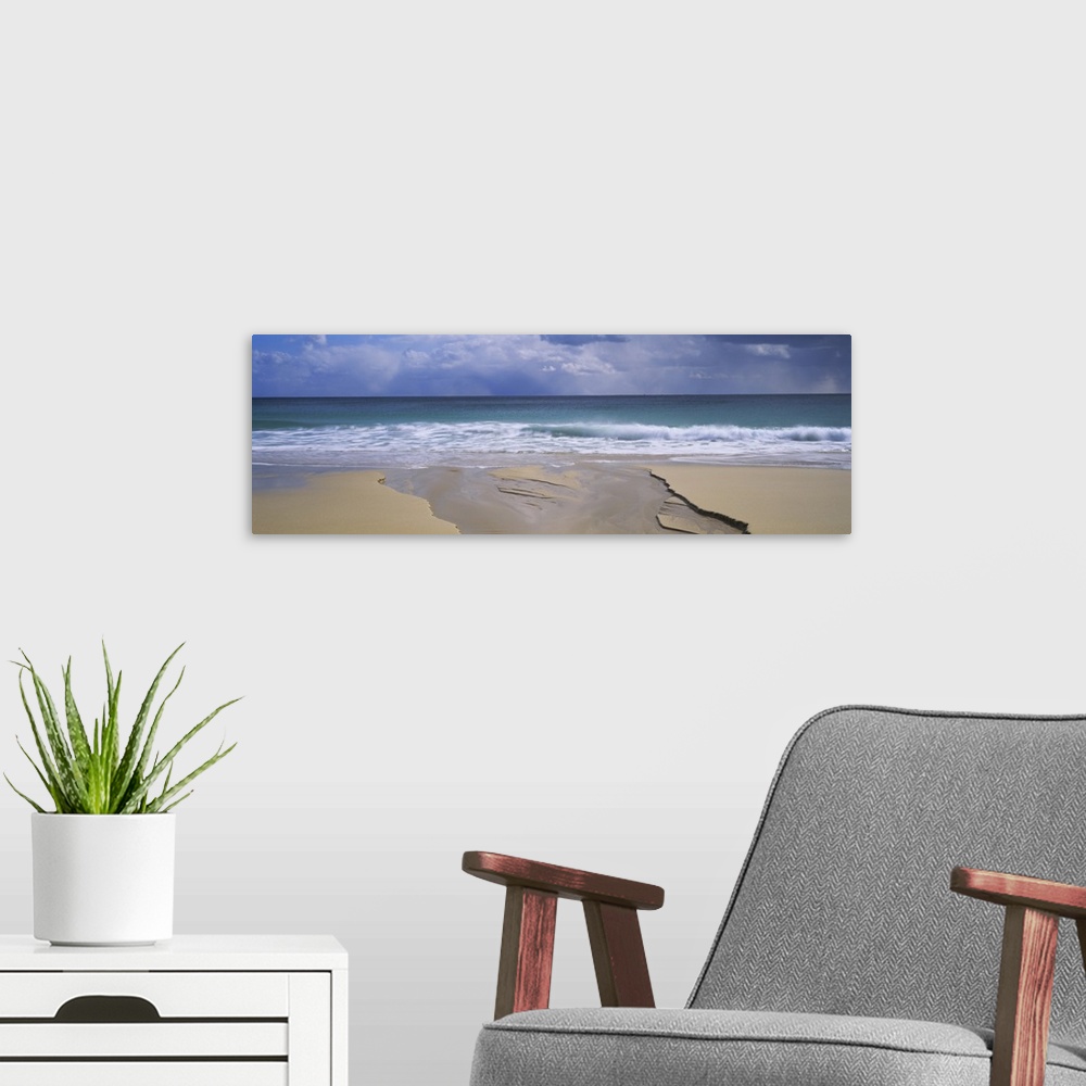 A modern room featuring Waves breaking on the beach, Porthcurno Bay, Cornwall, England