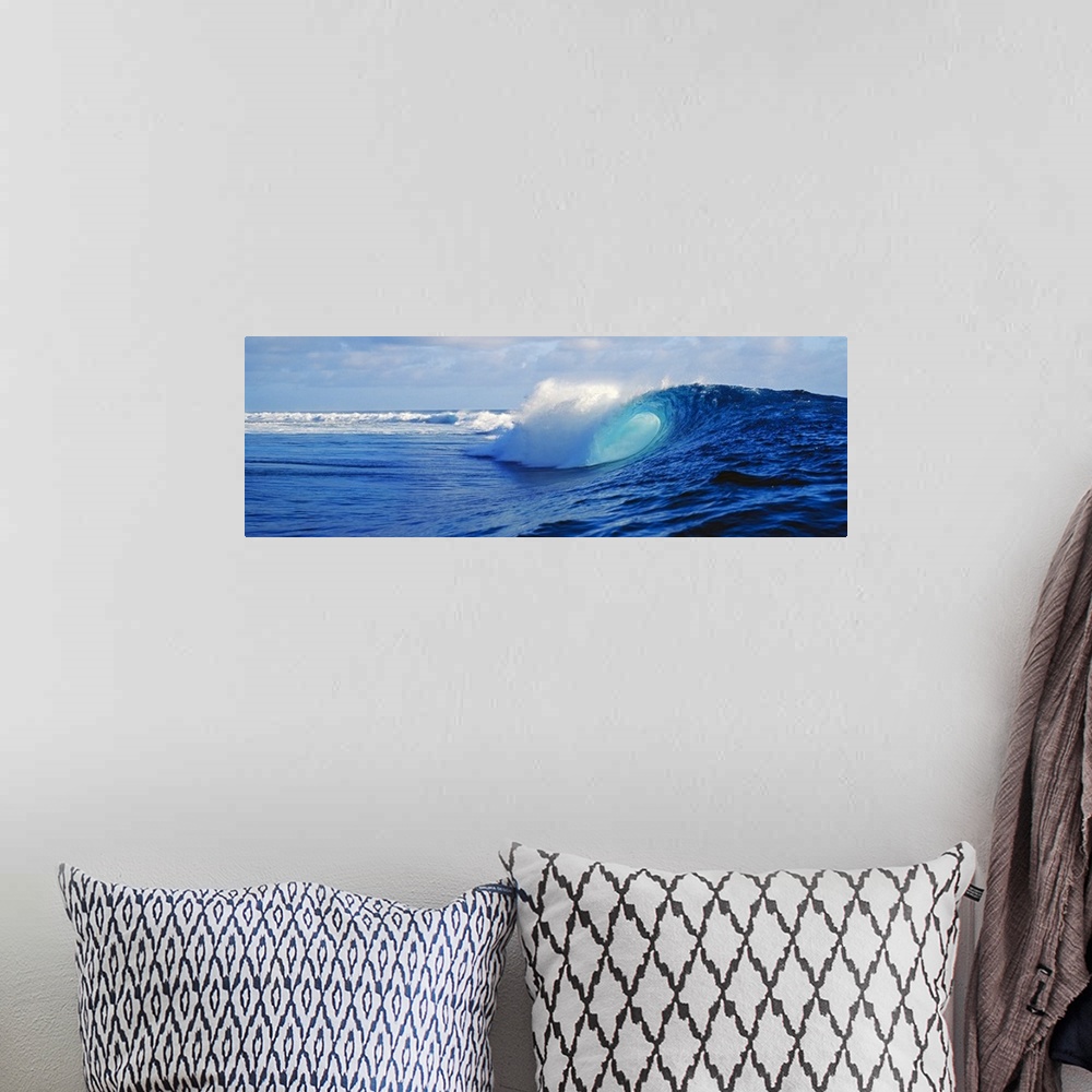 A bohemian room featuring Big canvas art of huge waves crashing in the ocean with no beach in sight.