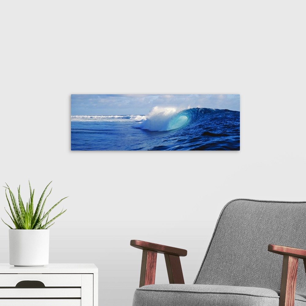 A modern room featuring Big canvas art of huge waves crashing in the ocean with no beach in sight.