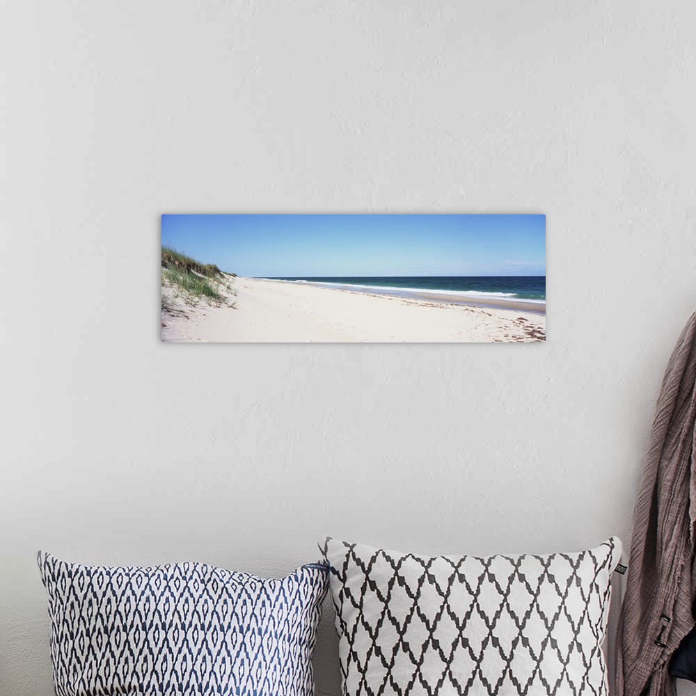 A bohemian room featuring Panoramic photograph taken of the beach with the sand dunes just to the left and the ocean water ...