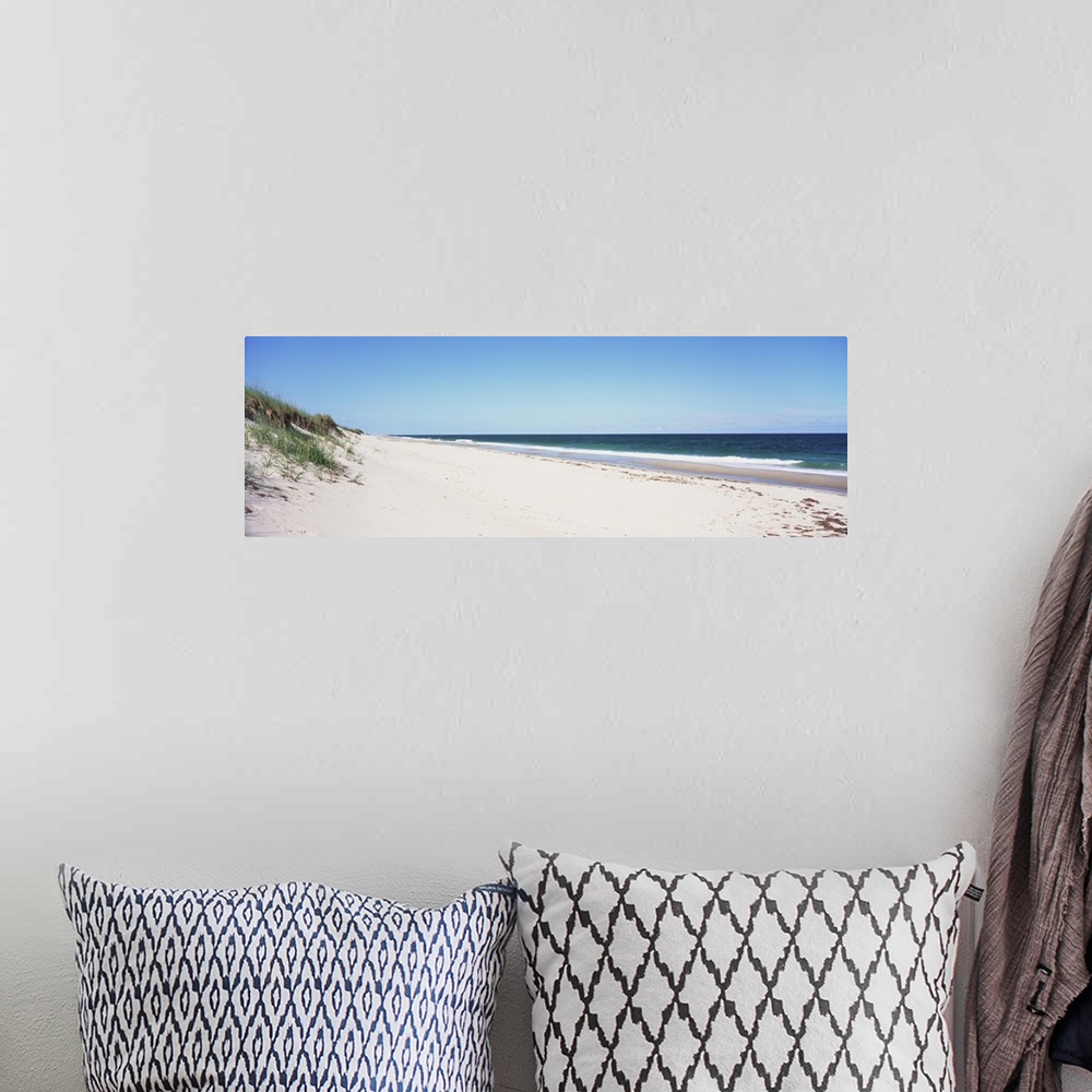 A bohemian room featuring Panoramic photograph taken of the beach with the sand dunes just to the left and the ocean water ...