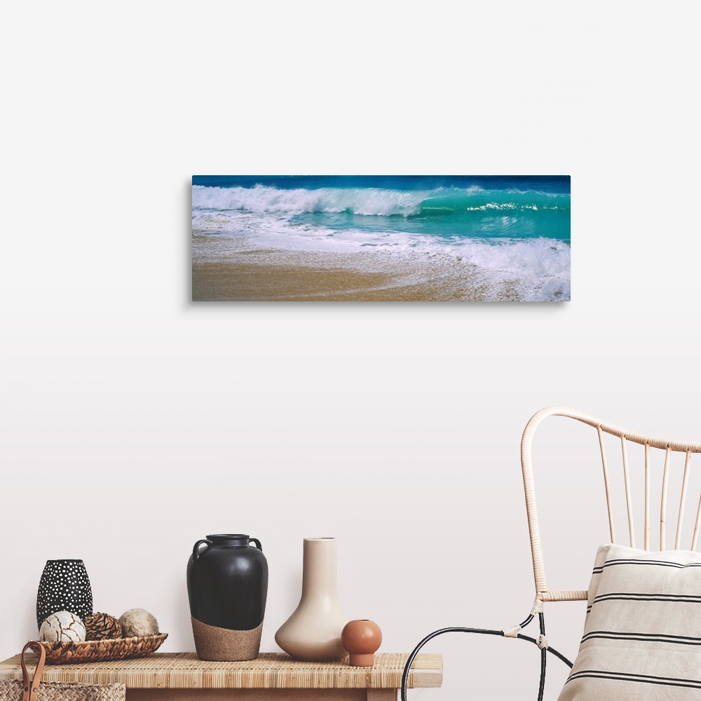 A farmhouse room featuring Panoramic photograph of water crashing onto the sand and being swept back out to sea.