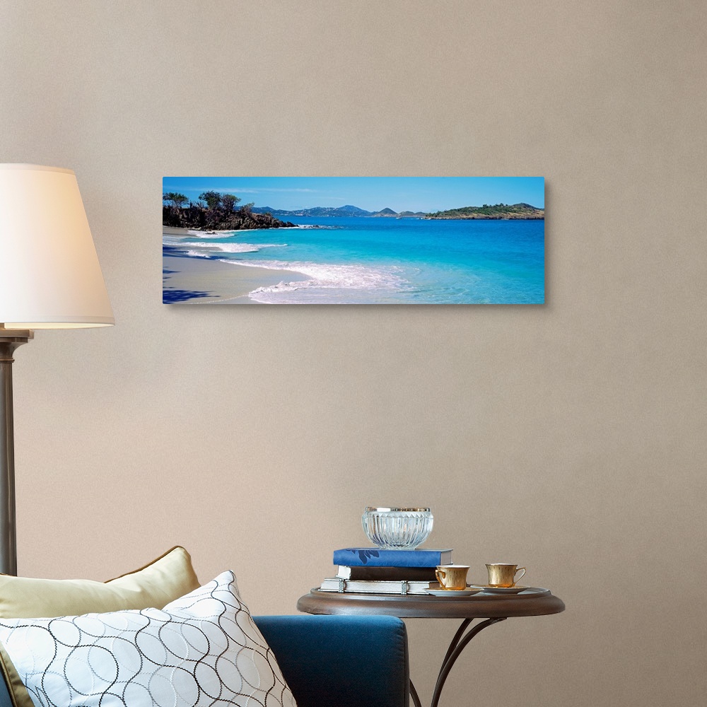 A traditional room featuring Panoramic photograph displays the calm waters of this bay slowly crashing into the sandy beach, w...