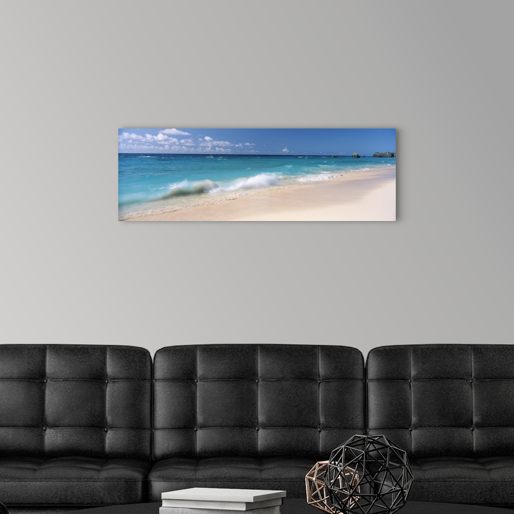 A modern room featuring Tropical scene of clear turquoise ocean waves splashing on the sandy beach in the Caribbean, some...