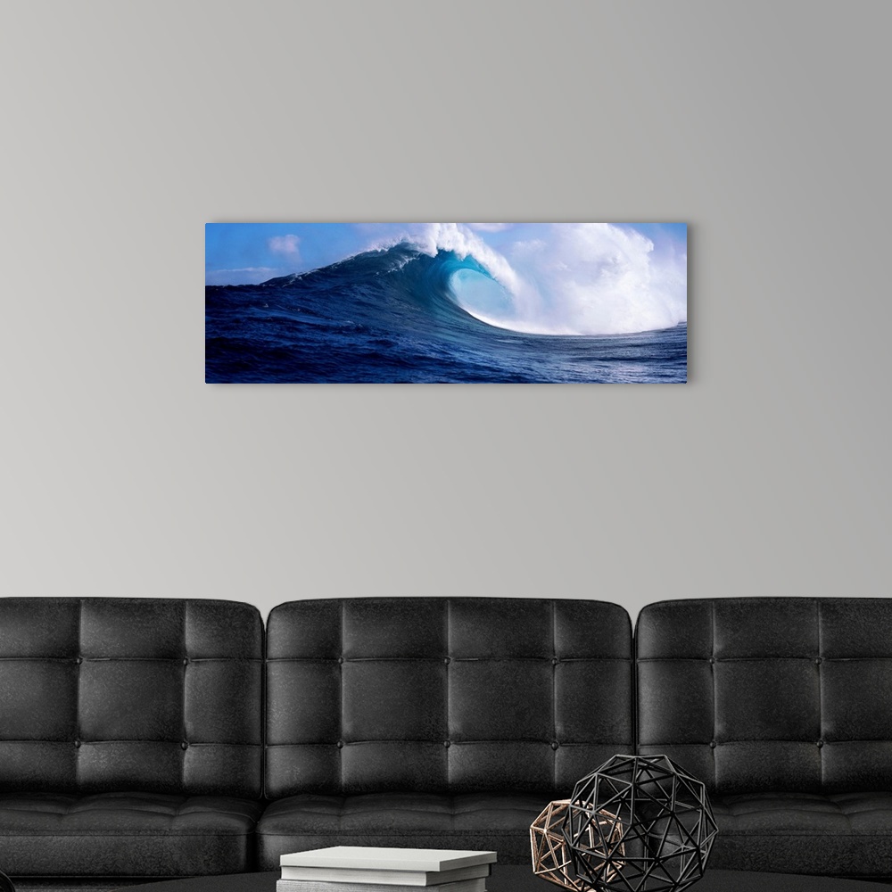 A modern room featuring A panoramic photograph capturing a plunging wave in motion as it prepares to break on the surface...