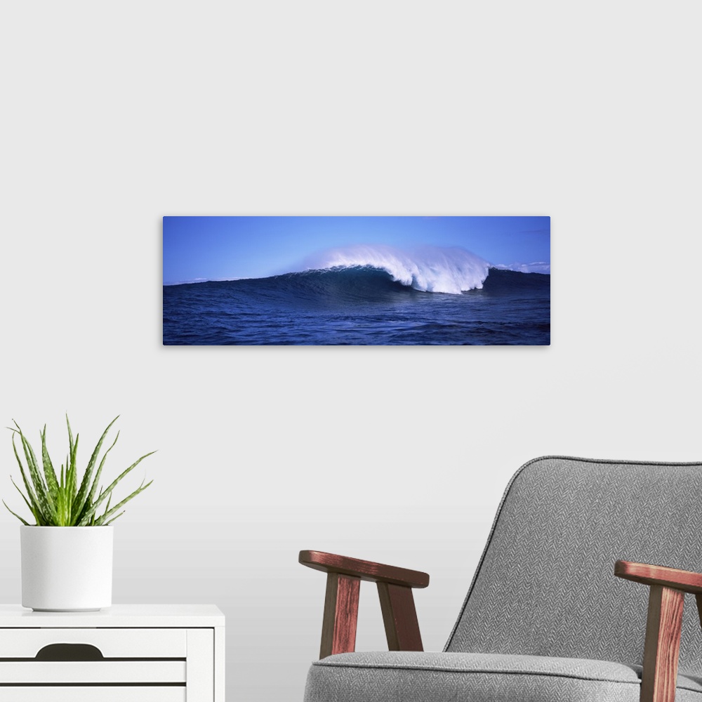 A modern room featuring Long canvas photo of a big wave crashing in the ocean.