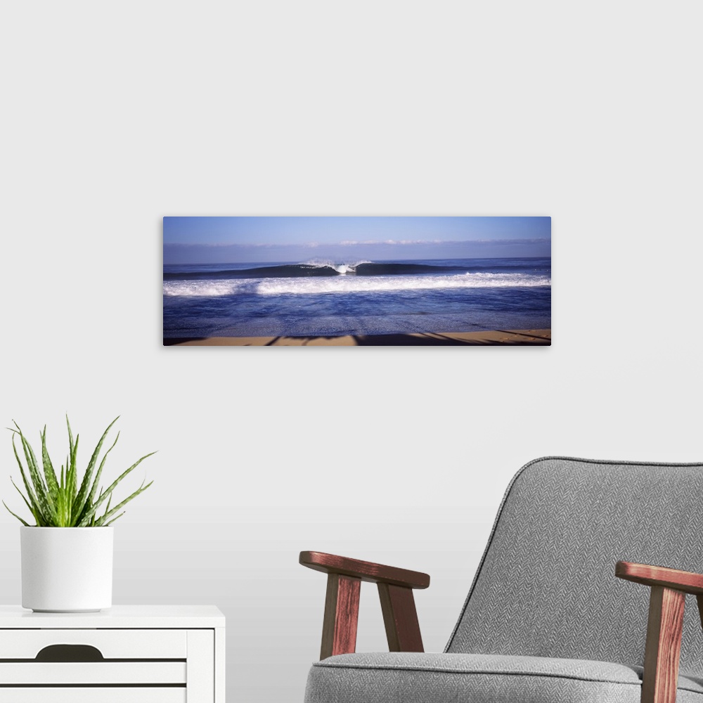 A modern room featuring Panoramic photo print of a big wave breaking in the middle washing ashore in Hawaii.