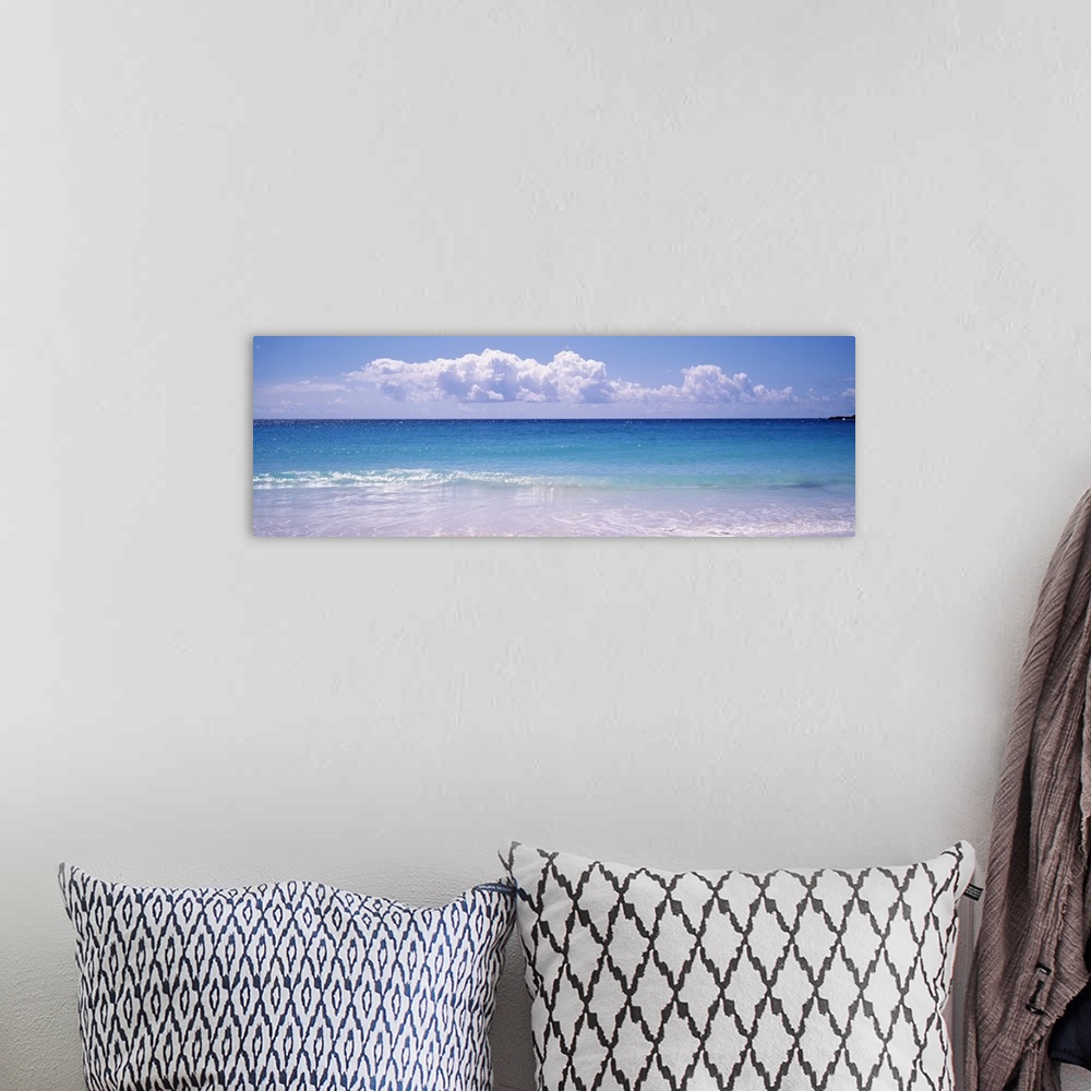 A bohemian room featuring Giant, landscape photograph of a shoreline in Vieques, Puerto Rico.  Small waves of clear blue wa...