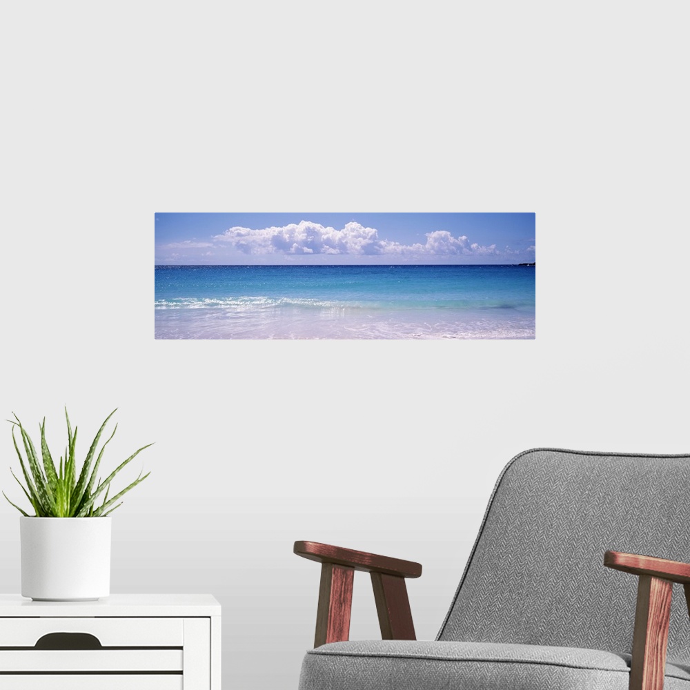 A modern room featuring Giant, landscape photograph of a shoreline in Vieques, Puerto Rico.  Small waves of clear blue wa...